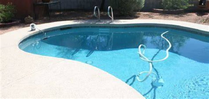 How do you clean a pebble pool deck?