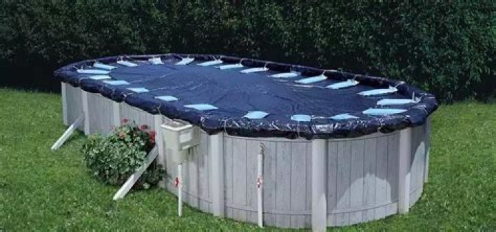 How do you keep wind from blowing up a pool cover?