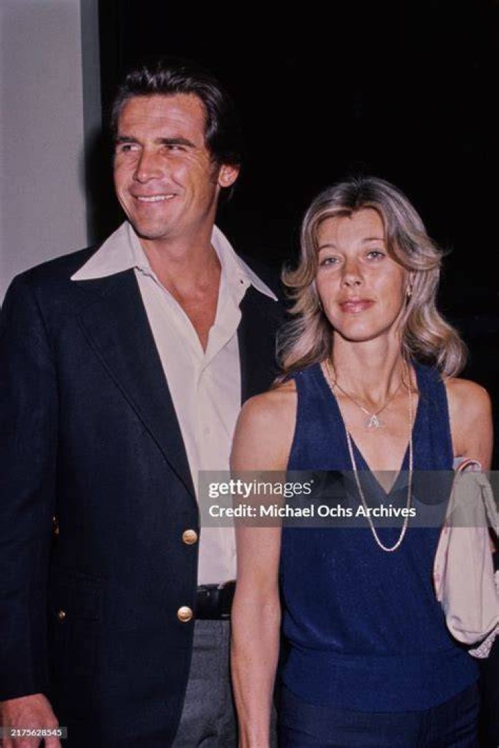 James Brolin wearing a black zipped turtle neck and Molly wearing a black fishnet top with a black inner top.