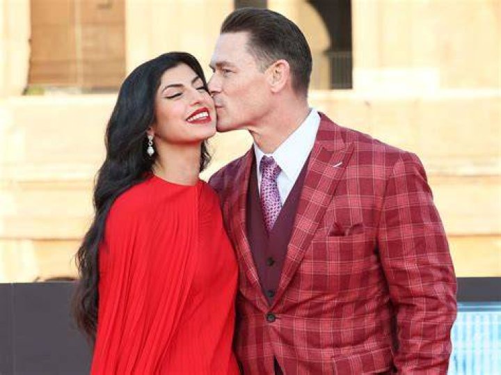 John With His Wife (Source: CelebSuburb)