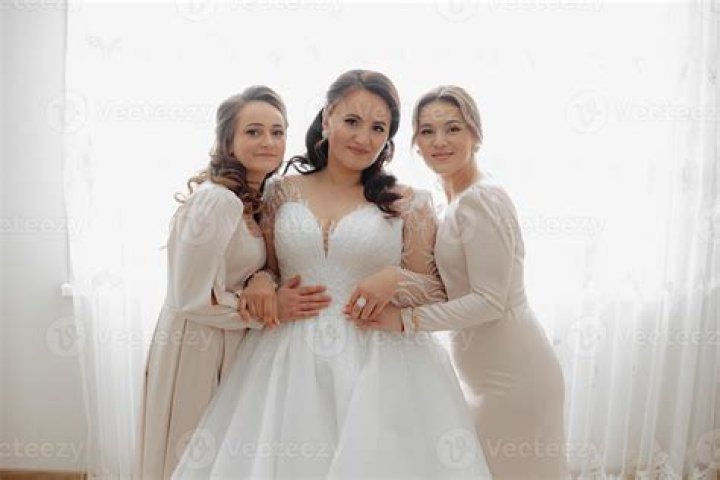 They are posing for the camera wearing a fluffy jacket and a matching black skirt.