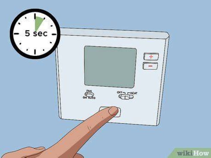 Where is the reset button on a thermostat?
